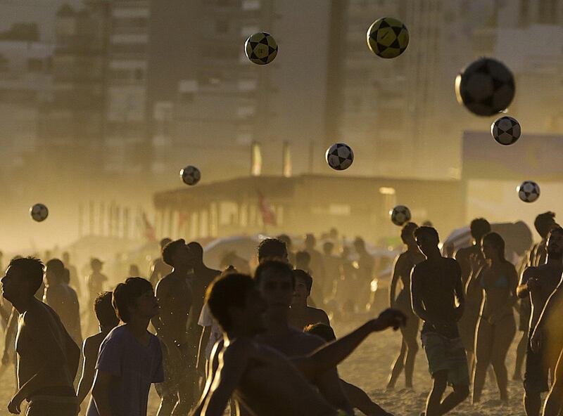 People throw balls at the Ipanema beach during a hot day in Rio de Janeiro. EPA