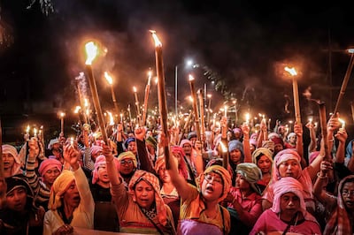 Women belonging to the 'Meira Paibis' hold torches during a demonstration in Manipur state. AFP