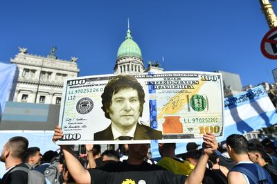 A supporter holds a giant dollar bill featuring the face of Javier Milei outside the Argentinian National Congress ahead of his inauguration in Buenos Aires on December 10. Getty Images