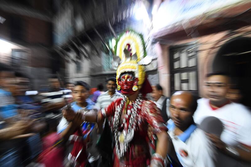A traditional Nepali masked dancer prepares to perform on the  last day of the Indra Jatra Festival in Kathmandu. AFP