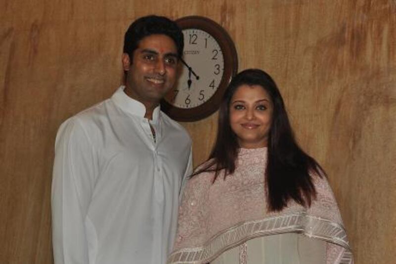 Indian actors Abhishek Bachchan (L) and Aishwarya Rai Bachchan pose for a photo as they speak to the media about their new daughter in Mumbai on November 22, 2011. Actress Aishwarya Rai Bachchan, gave birth to her first baby at Seven Hills Hospital in Mumbai on 16th November and was discharged from the hospital a week after her delivery. AFP PHOTOS/ STR