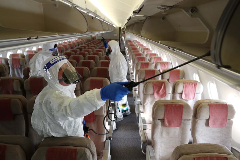 Officials disinfect the cabin of an Asiana Airlines plane at Incheon International Airport in South Korea amid mounting concerns about the Omicron variant. EPA