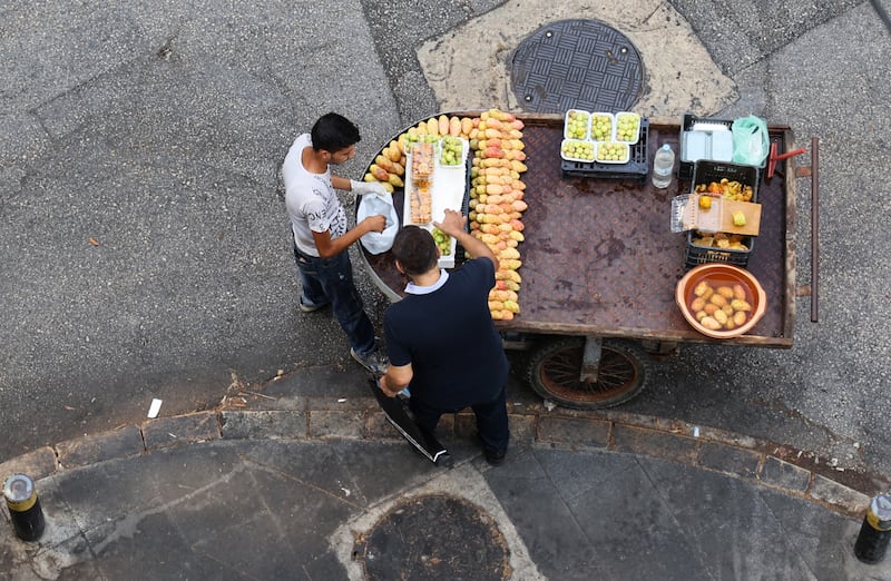 A Lebanese customer buys prickly pears and figs from a street vendor in the capital Beirut. AFP