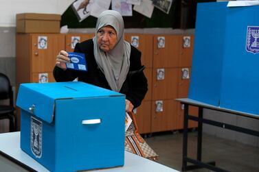 An Israeli Arab elderly citizen from Taiybe town casts her ballot at a polling station, during the Elections of the 21st Knesset of Israel. EPA