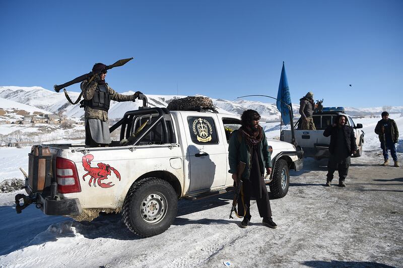 In this photo taken on January 9, 2021, Hazara armed militia for the Resistance for Justice Movement, keep watch along a road covered in snow in front of their base during a patrol against Taliban insurgents at Hisa-e-Awali Behsud district of Maidan Wardak Province. - Comprising roughly 10 to 20 percent of Afghanistan's 38-million population, Hazaras have long been persecuted for their largely Shiite faith by Sunni hardliners in a country wracked by deep ethnic divisions. (Photo by WAKIL KOHSAR / AFP) / TO GO WITH'Afghanistan-Hazara-violence', by David STOUT, Najiba NOORI