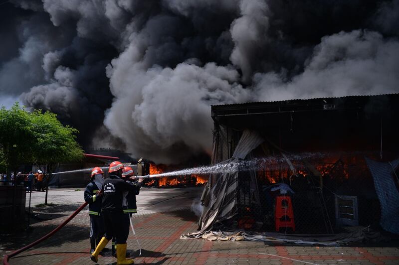 Plumes of black smoke rise from the baazar.