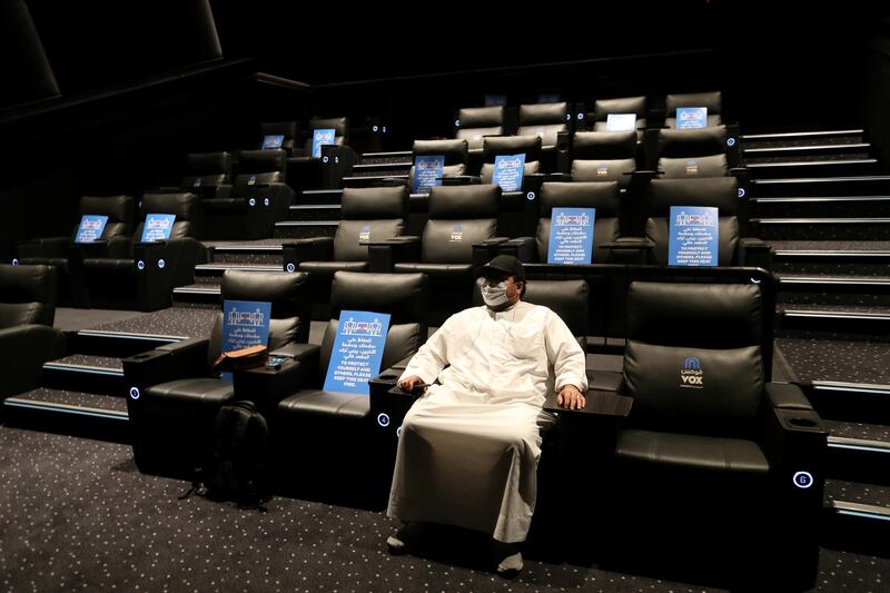 A Saudi man wearing a protective mask sits at VOX Cinema hall in Riyadh Park Mall, after the government lifted the coronavirus lockdown restrictions in Riyadh, Saudi Arabia June 25, 2020. REUTERS/Ahmed Yosri