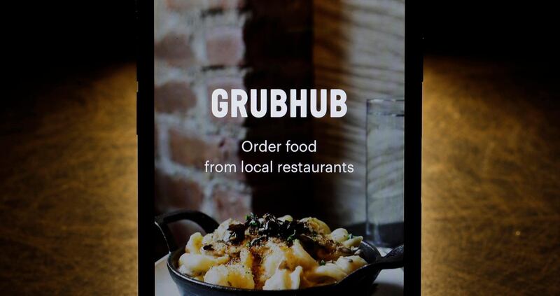 FILE - This Feb. 20, 2018, file photo shows the Grubhub app on an iPhone in Chicago. Just Eat Takeaway.com is acquiring Grubhub in a $7.3 billion deal that will create one of the world's largest restaurant delivery companies. Amsterdam-based Just Eat Takeaway.com and Chicago-based Grubhub announced the merger late Wednesday, June 10, 2020. Earlier in the day Just Eat Takeaway.com confirmed the two companies were in talks. (AP Photo/Charles Rex Arbogast, File)