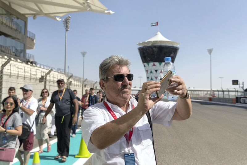 Abu Dhabi, United Arab Emirates, November 23, 2017:    Fans walk through pit lane during previews for the Abu Dhabi Formula One Grand Prix at Yas Marina Circuit in Abu Dhabi on November 23, 2017. Christopher Pike / The National

Reporter: John McAuley, Graham Caygill
Section: Sport