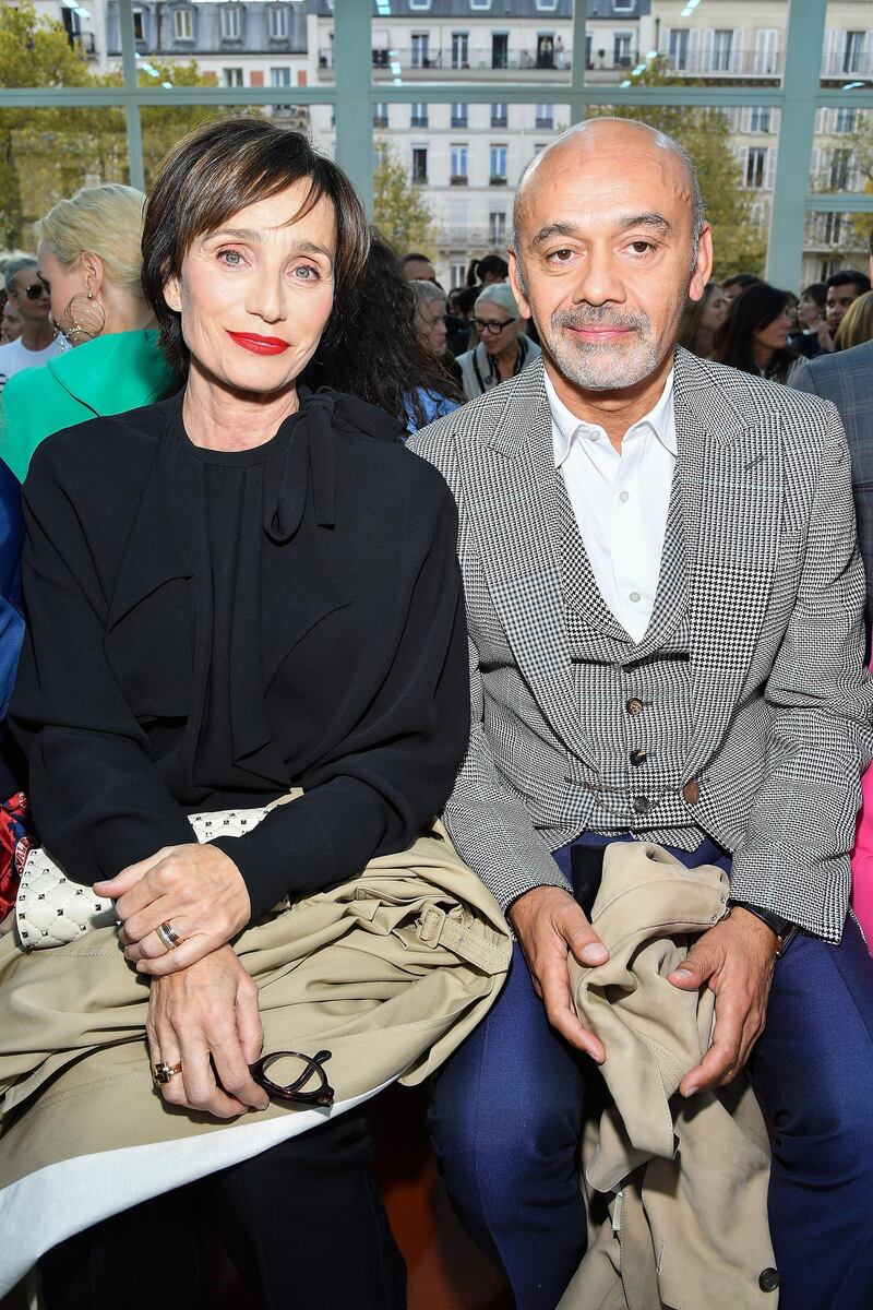 PARIS, FRANCE - SEPTEMBER 30:  (L-R) Kristin Scott Thomas and Christian Louboutin a guest attend the Valentino show as part of the Paris Fashion Week Womenswear Spring/Summer 2019 on September 30, 2018 in Paris, France.  (Photo by Pascal Le Segretain/Getty Images)