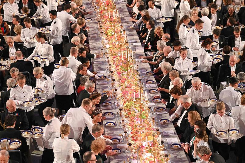 Waiters serve dessert during the royal banquet in honour of the laureates of the Nobel Prize 2022, following the awards ceremony in Stockholm, Sweden. AFP