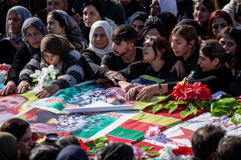 Syrian Kurds at a funeral of people killed in Turkish air strikes in the village of Al Malikiyah in northern Syria on Monday. AP