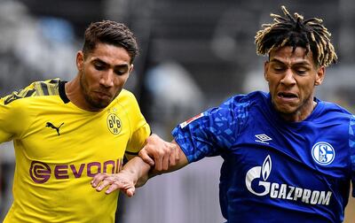 Soccer Football - Bundesliga - Borussia Dortmund v Schalke 04 - Signal Iduna Park, Dortmund, Germany - May 16, 2020 Dortmund's Achraf Hakimi in action with Schalke's Jean-Clair Todibo, as play resumes behind closed doors following the outbreak of the coronavirus disease (COVID-19) Martin Meissner/Pool via REUTERS  DFL regulations prohibit any use of photographs as image sequences and/or quasi-video