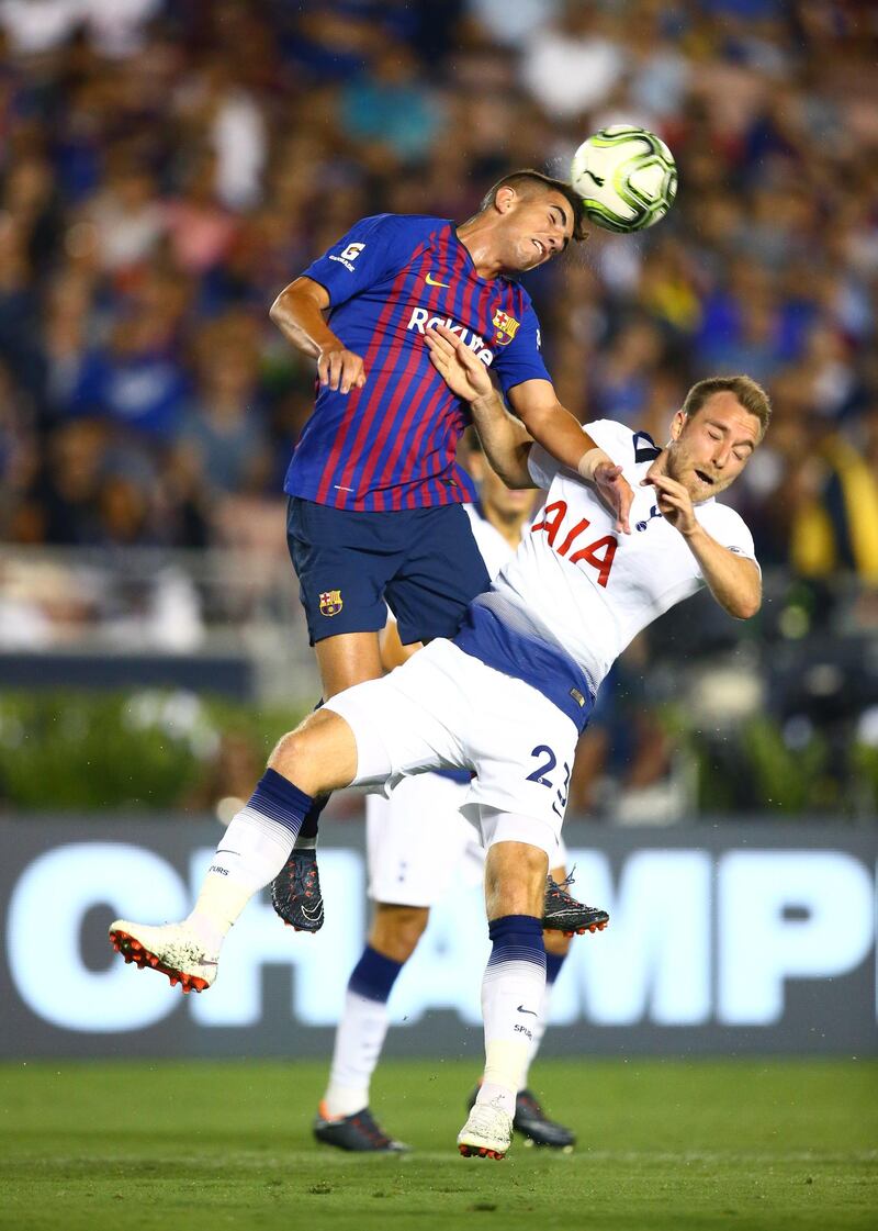 Barcelona midfielder Monchu heads the ball against Tottenham Hotspur midfielder Christian Eriksen. Reuters