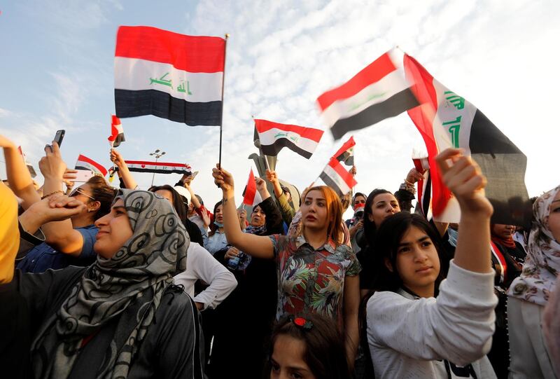 Women demonstrators hold Iraqi flags as they take part in a protest over corruption, lack of jobs, and poor services, in Baghdad, Iraq. Reuters