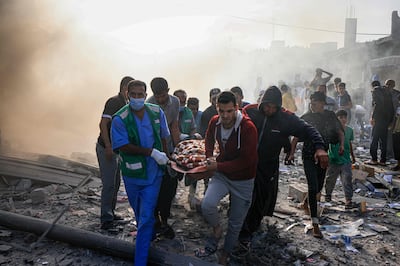 Palestinians carry a victim of Israeli bombardment in Khan Younis, in Gaza. AFP