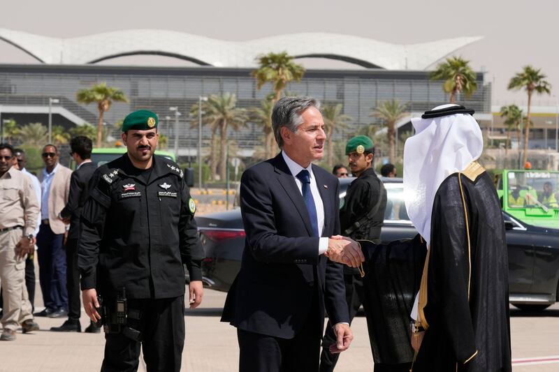 Mr Blinken shakes hands with a Saudi official before boarding a plane leaving Riyadh. AP