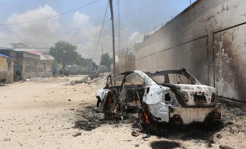 A burning car in Madina district of Somalia's capital Mogadishu, on  April 16, 2017 after a clash between gunmen and security forces.  Feisal Omar / Reuters 