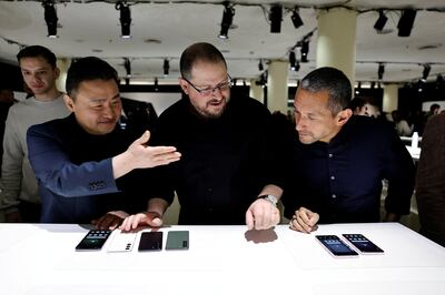 TM Roh, left, president and head of mobile experience business at Samsung, Cristiano Amon, centre, president of Qualcomm, and Hiroshi Lockheimer, senior vice president, platforms and ecosystems at Google, look at the new S23 series phones in San Francisco. Reuters
