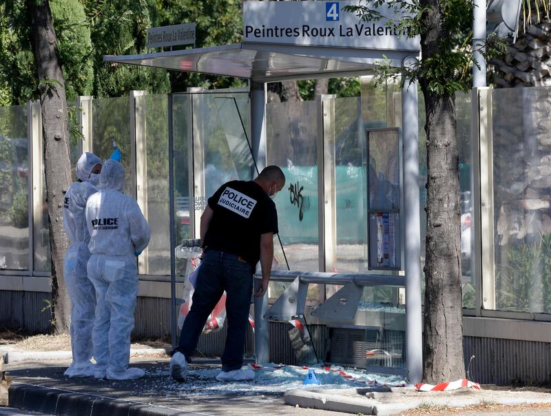 Policce officers inspect a bus stop in La Valentine district after a van rammed into two bus stops in the French port city of Marseille, southern France. Claude Paris / AP Photo