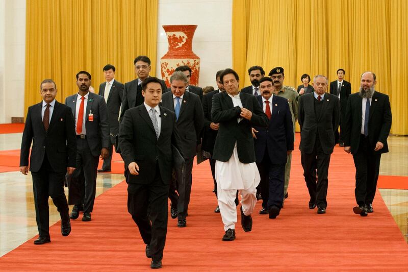 Pakistan's Prime Minister Imran Khan (C-white trousers) arrives to meet China's President Xi Jinping (not pictured) at the Great Hall of the People in Beijing.  AFP