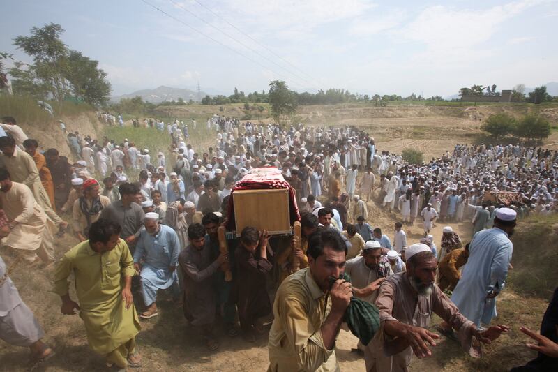 People carry the coffins of victims of a suicide a blast in the Bajaur district of Pakistan's Khyber Pakhtunkhwa province. Reuters