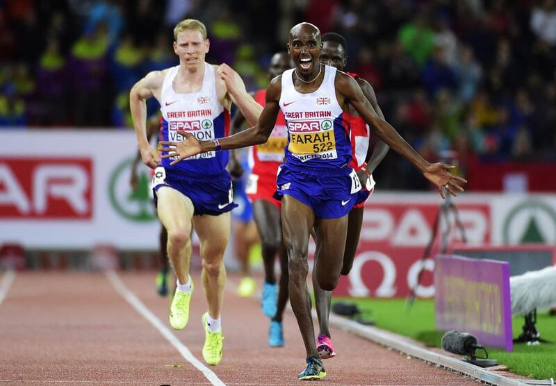 Great Britain's Mohamed Farah, front, reacts as he crosses the finish line ahead of teammate Andy Vernon, left, to win the men's 10000m final during the European Championships at the Letzigrund Stadium in Zurich on August 13, 2014. Olivier Morin / AFP 