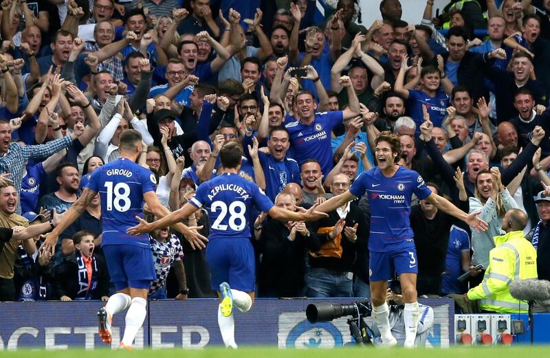 Chelsea's Marcos Alonso, right, celebrates after scoring his side's third goal during the English Premier League soccer match between Chelsea and Arsenal at Stamford bridge stadium in London, Saturday, Aug. 18, 2018. (AP Photo/Tim Ireland)