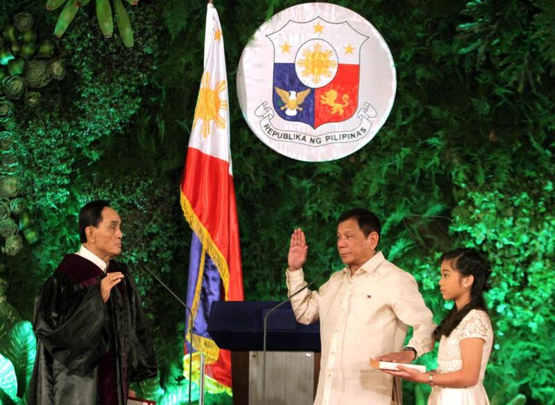 New Philippine President Rodrigo Duterte takes his oath as Philippines’ 16th president at Malacanang Palace in Manila. The News and Information Bureau, Malacanang Palace via AP