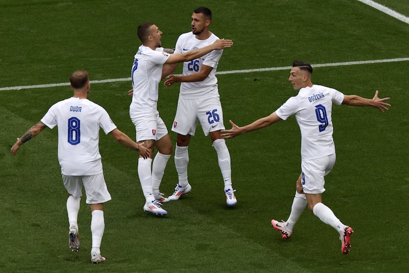 Ivan Schranz, second right, celebrates with his Slovakia teammates after scoring. EPA