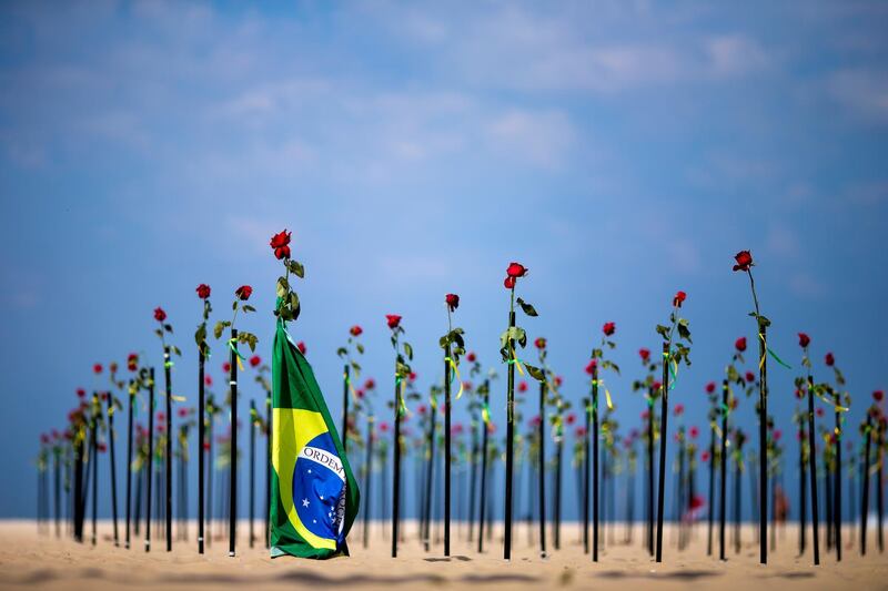 Hundreds of red roses have been planted at Copacabana Beach in Rio de Janeiro, Brazil, to mark the deaths of more than 500,000 Covid-19 patients and protest against the country's response to the pandemic. Getty