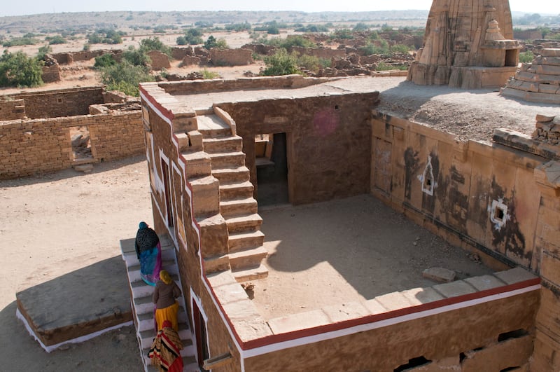 Tourists explore a restored dwelling in Kuldhara, situated in the north-western Indian state of Rajasthan