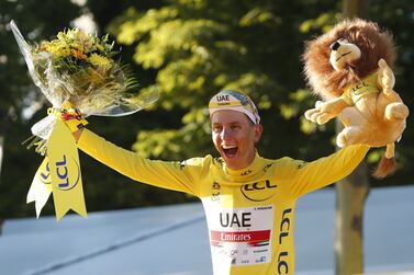 Slovenian rider Tadej Pogacar of the UAE-Team Emirates celebrates on the podium with the overall leader's yellow jersey after the 21st stage of the Tour de France 2021 over 108. 4 km from Chatou to Paris, France, 18 July 2021.   EPA / GUILLAUME HORCAJUELO