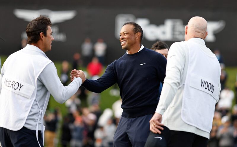 Tiger Woods and Harry Diamond, caddie for Rory McIlroy, at the end of the first round. AFP