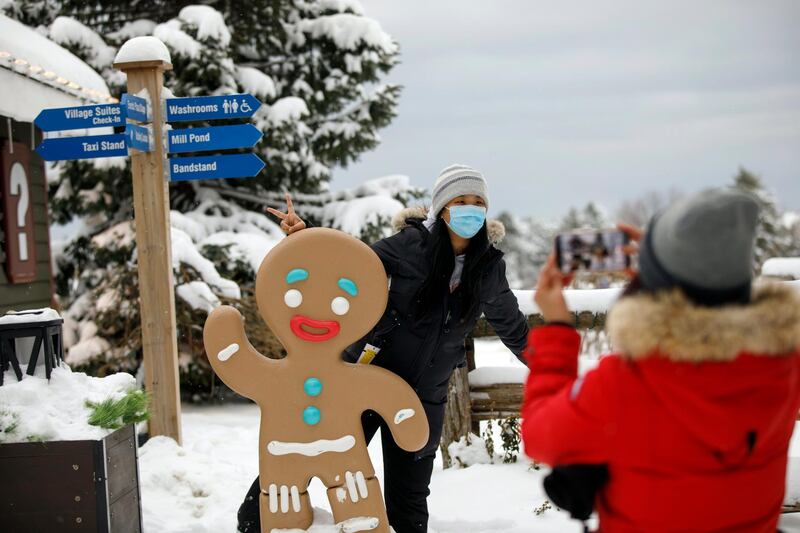 Guests take photos in the village of Blue Mountain Ski Resort in The Blue Mountains, Ontario, Canada. The Canadian Press via AP