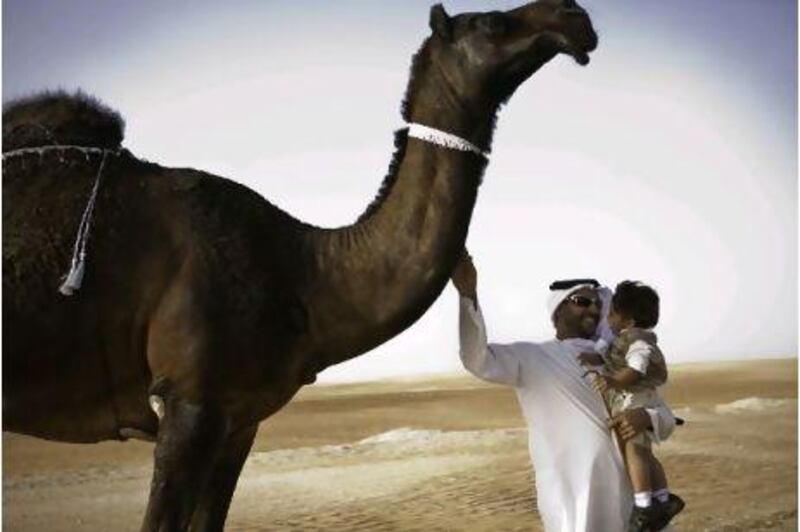 Sheikh Diab and his son, Mohammed, with Al Hikmah, his prize-winning camel.
