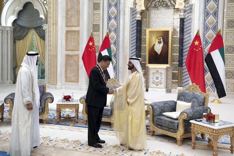 ABU DHABI, UNITED ARAB EMIRATES - July 20, 2018: HH Sheikh Mohamed bin Rashid Al Maktoum, Vice-President, Prime Minister of the UAE, Ruler of Dubai and Minister of Defence (R) and HH Sheikh Mohamed bin Zayed Al Nahyan, Crown Prince of Abu Dhabi and Deputy Supreme Commander of the UAE Armed Forces (L) present a Zayed Medal to HE Xi Jinping, President of China (C), during a reception at the Presidential Palace. 

( Hamad Al Kaabi / Crown Prince Court - Abu Dhabi )
---