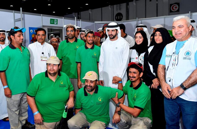 Sheikh Hamdan bin Mohammed poses for a photo with members of the Zayed Higher Organisation for Humanitarian Care at the Special Olympics Mena Games. Wam