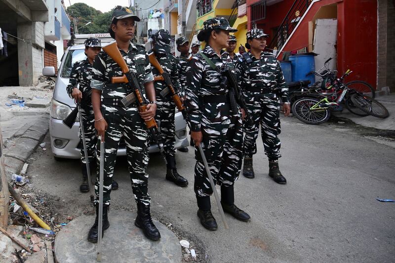 Central Reserve Police Force members stand guard in Bangalore, India on September 22 as the National Investigation Agency raids the offices of the Popular Front of India over terror-funding charges. EPA
