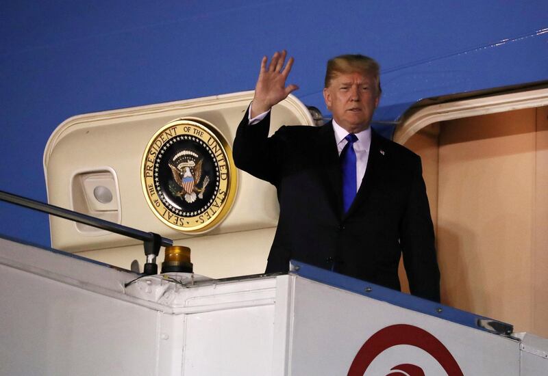 U.S. President Donald Trump waves as he disembarks Air Force One after arriving in Singapore June 10, 2018.  REUTERS/Jonathan Ernst