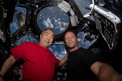 TOPSHOT - This NASA handout photo obtained May 2, 2021 shows Expedition 65 Flight Engineers Soichi Wakata(L) of the Japan Aerospace Exploration Agency and Thomas Pesquet of the European Space Agency as they pose on April 28, 2021 for a portrait inside the cupola, the International Space Station's "window to the world." RESTRICTED TO EDITORIAL USE - MANDATORY CREDIT "AFP PHOTO /NASA/HANDOUT " - NO MARKETING - NO ADVERTISING CAMPAIGNS - DISTRIBUTED AS A SERVICE TO CLIENTS
 / AFP / NASA / Handout / RESTRICTED TO EDITORIAL USE - MANDATORY CREDIT "AFP PHOTO /NASA/HANDOUT " - NO MARKETING - NO ADVERTISING CAMPAIGNS - DISTRIBUTED AS A SERVICE TO CLIENTS
