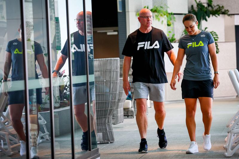 Ashleigh Barty and Craig Tyzzer walk to a press conference in Brisbane after she announced her retirement from tennis.  AFP