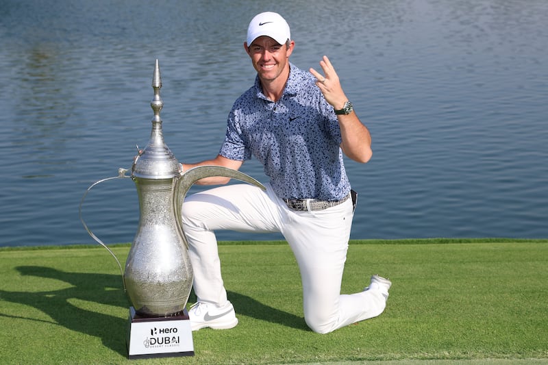 DUBAI, UNITED ARAB EMIRATES - JANUARY 30: Rory McIlroy of Northern Ireland poses with the Hero Dubai Desert Classic trophy on the 18th green, following victory in the Final Round on Day Five of the Hero Dubai Desert Classic at Emirates Golf Club on January 30, 2023 in Dubai, United Arab Emirates. (Photo by Warren Little / Getty Images)