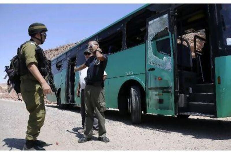 An Israeli soldier scans the aftermath of the bus ambush north of Eilat in the Sinai Thursday.