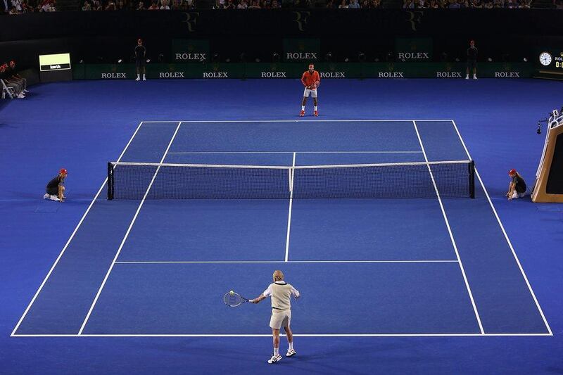 Laver and Federer rallying on Wednesday. Graham Denholm / Getty Images