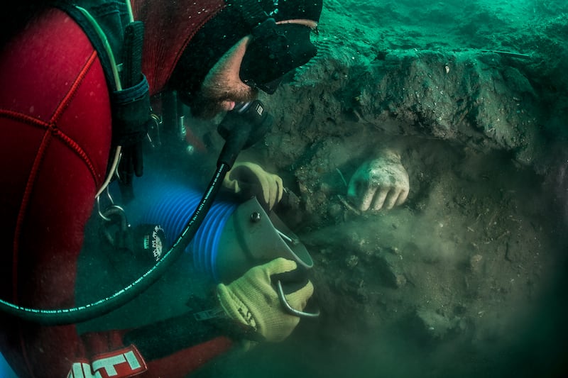 A diver uncovers a votive hand during an archaeological excavation in Thonis-Heracleion, an ancient city about seven kilometres off Egypt's Mediterranean coast. Franck Goddio / Hilti Foundation