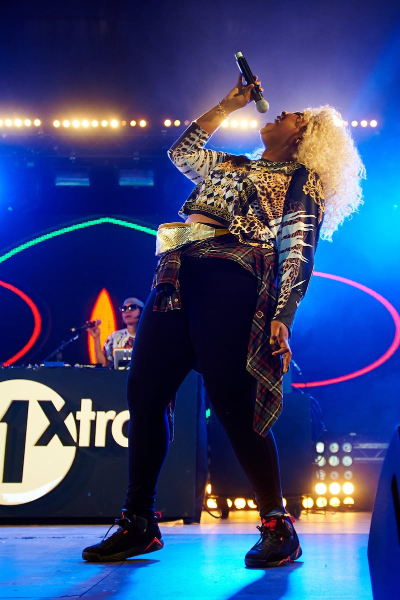 Lizzo wears a long-sleeved shirt, trousers and boots to perform on stage at Leeds Festival 2014 in the UK. Getty Images