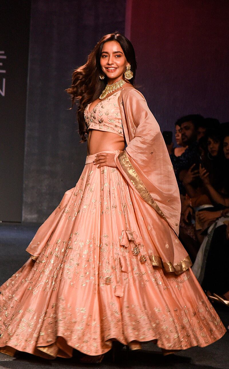 Bollywood actress Neha Sharma presents a creation by designer Kraft Peacock Couture at the Lakmé Fashion Week (LFW) Winter Festive 2019 in Mumbai on August 25, 2019.  - XGTY / RESTRICTED TO EDITORIAL USE
 / AFP / Sujit Jaiswal / XGTY / RESTRICTED TO EDITORIAL USE
