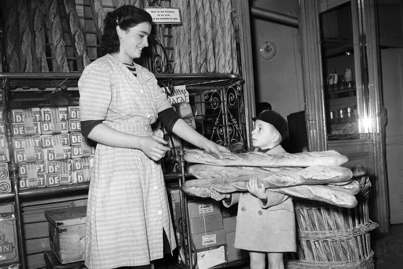 A little boy buys baguettes as Parisians stock up on bread for two days in preparation for a bakers' strike in Paris in 1949. AFP