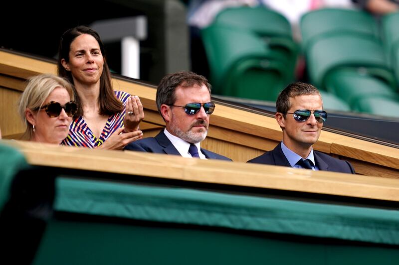 Bear Grylls (right) in the Royal Box on centre court on day four of Wimbledon at The All England Lawn Tennis and Croquet Club, Wimbledon.